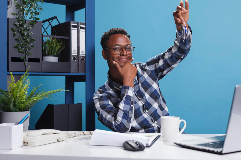 An employee at a desk with a cup of coffee.