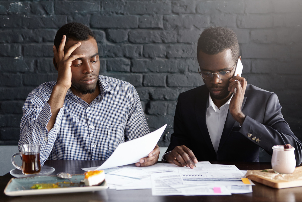 Two workers looking at payroll in the office