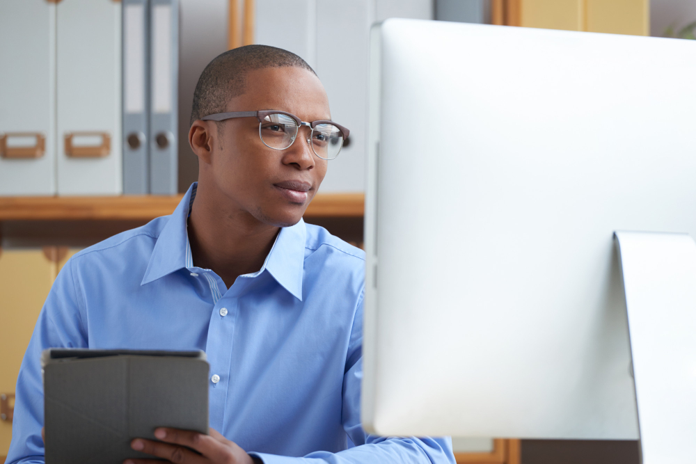 A young employee going through a payroll software in Ghana developed by JobHouse